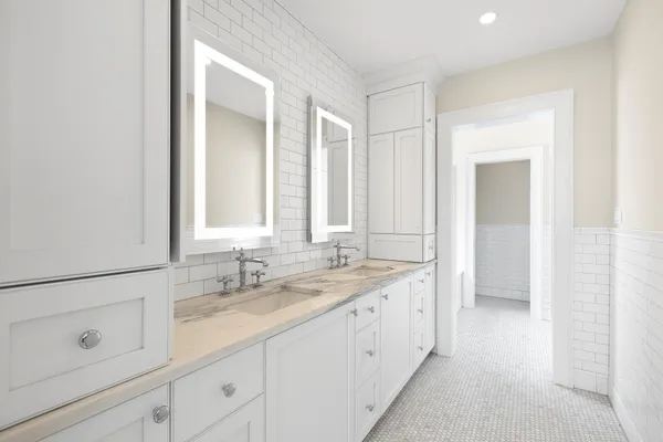 a bathroom with a double vanity sink and a mirror