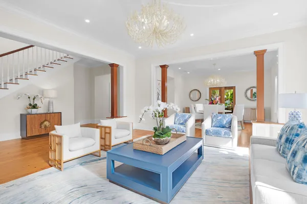 a living room with furniture and a chandelier