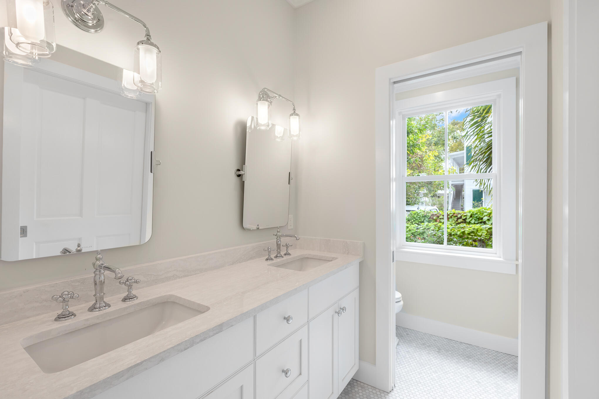 616 Eaton Street Key West, FL 33040 - Photo 48 of 62 a bathroom with a double vanity sink a mirror and a shower