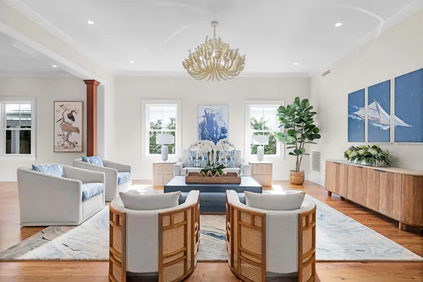a dining room with wooden floor and chandelier