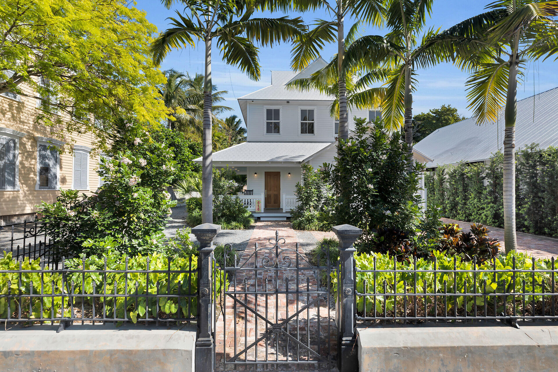 616 Eaton Street Key West, FL 33040 - Photo 57 of 62 a front view of a house with a yard and potted plants