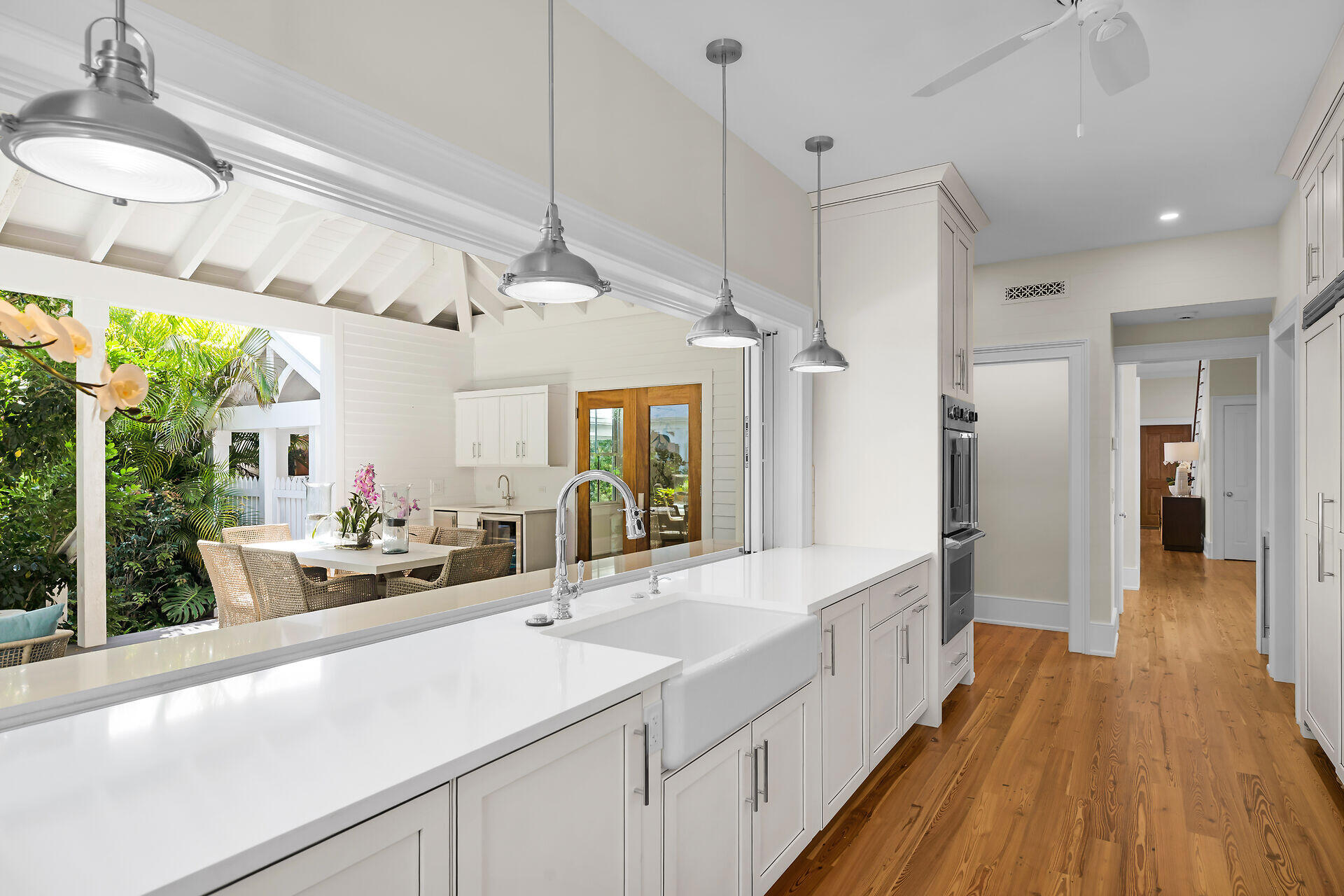 616 Eaton Street Key West, FL 33040 - Photo 9 of 62 a large white kitchen with a large window and stainless steel appliances