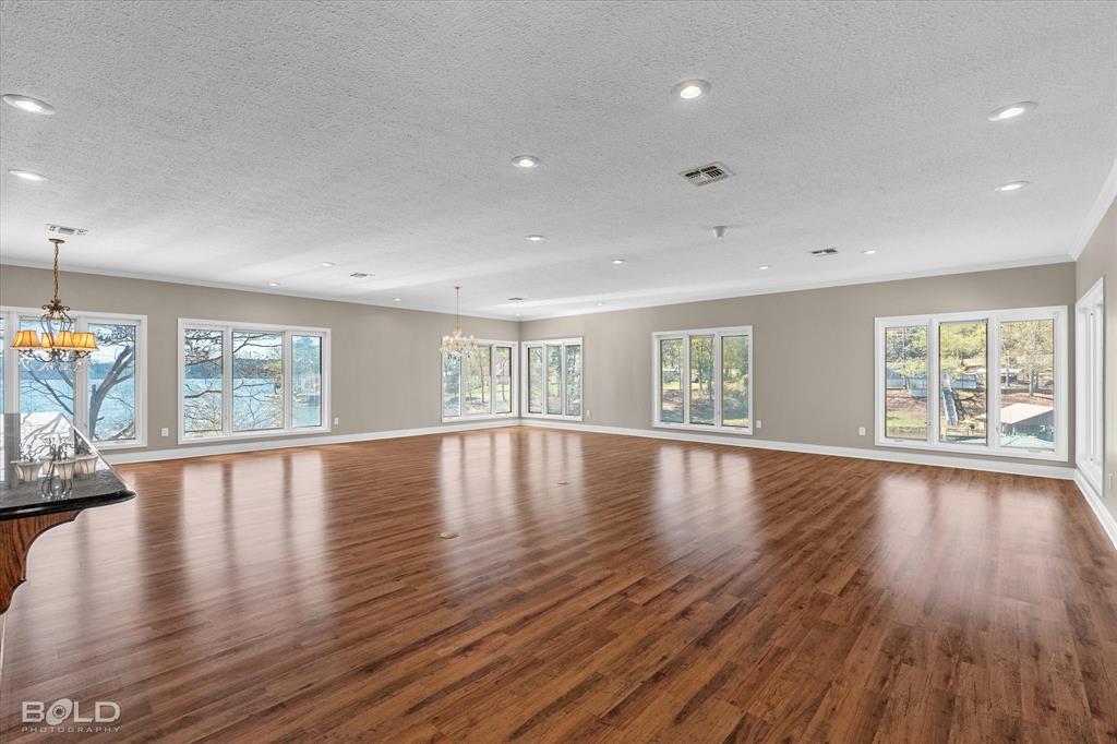 429 Robinson Lane Homer, LA 71040 - Photo 11 of 40 a view of an empty room with wooden floor and a window