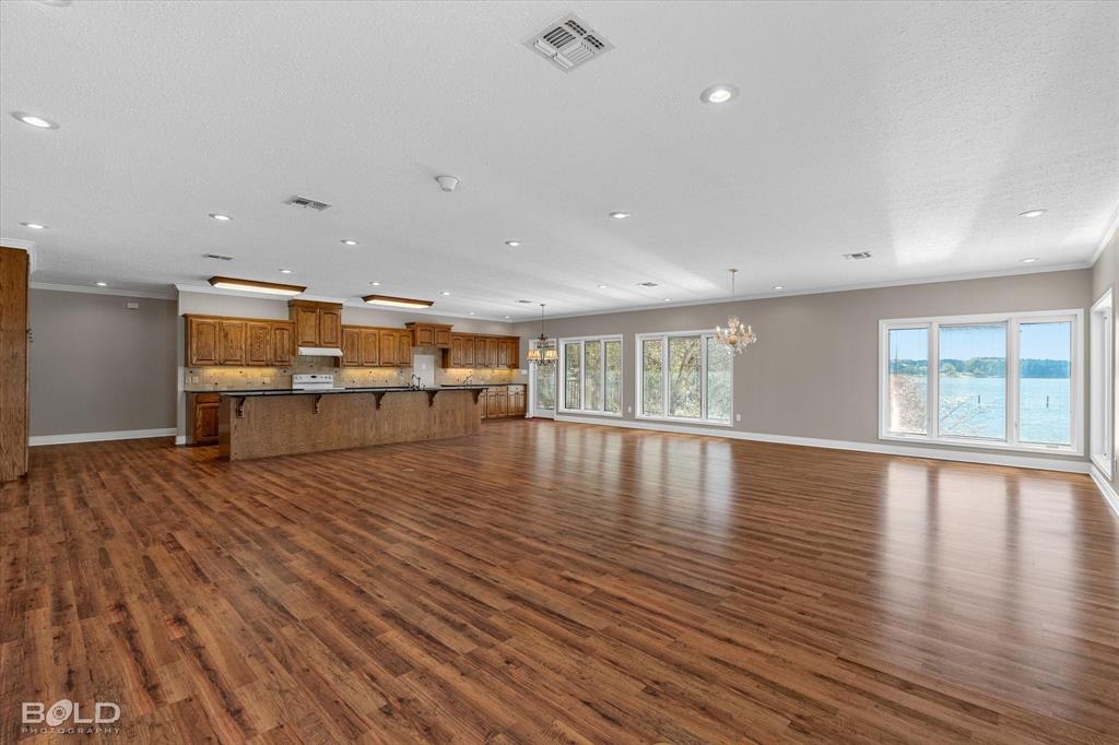 429 Robinson Lane Homer, LA 71040 - Photo 13 of 40 a view of an empty room with wooden floor and a window