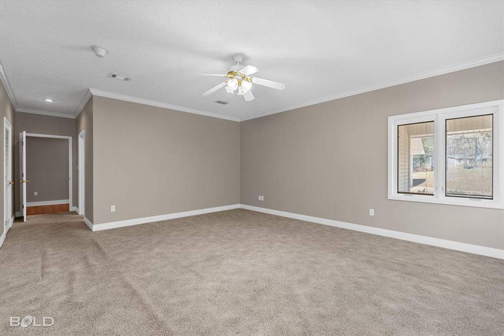 429 Robinson Lane Homer, LA 71040 - Photo 28 of 40 an empty room with windows and chandelier fan