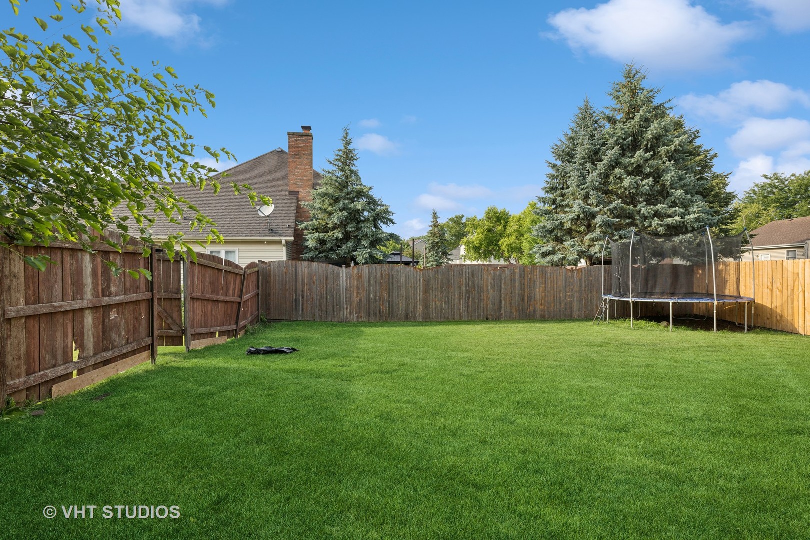 1177 Dovercliff Way Crystal Lake, IL 60014 - Photo 26 of 32 a view of a backyard with a garden and wooden fence