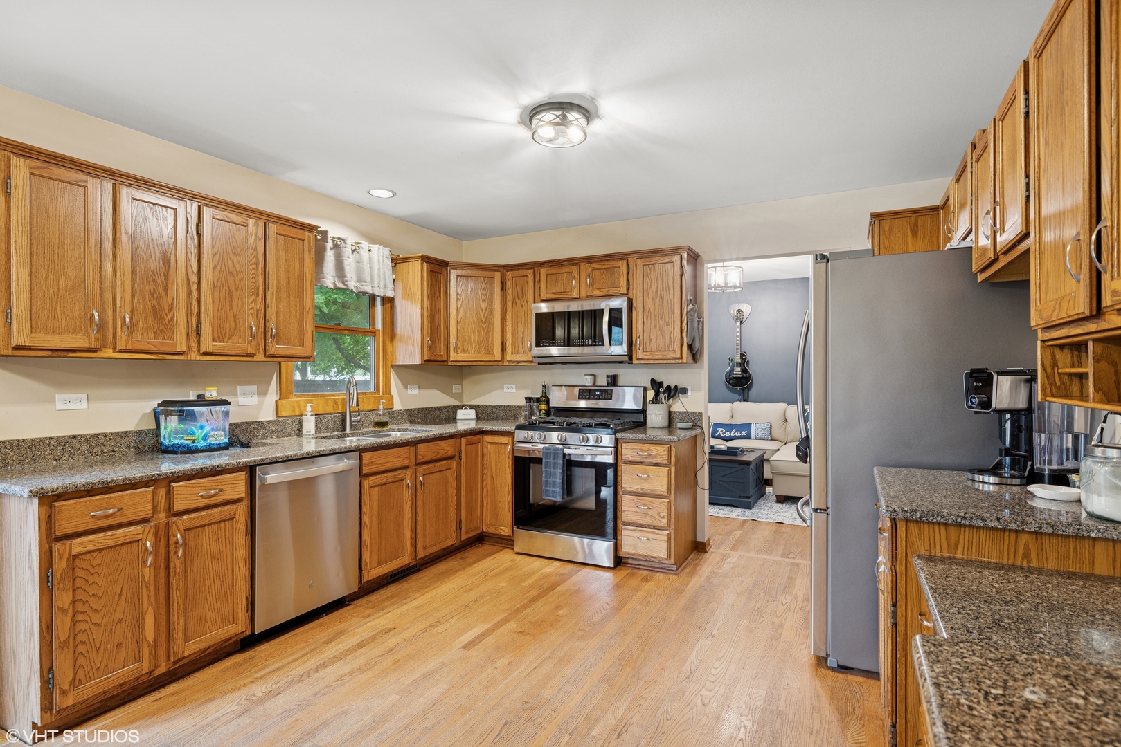 1177 Dovercliff Way Crystal Lake, IL 60014 - Photo 10 of 32 a kitchen with stainless steel appliances granite countertop wooden cabinets a refrigerator a stove a sink and a microwave