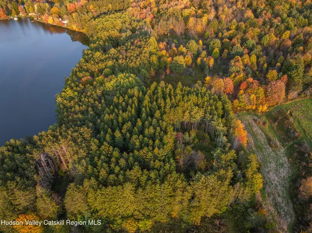 a view of a house with a garden and sitting area