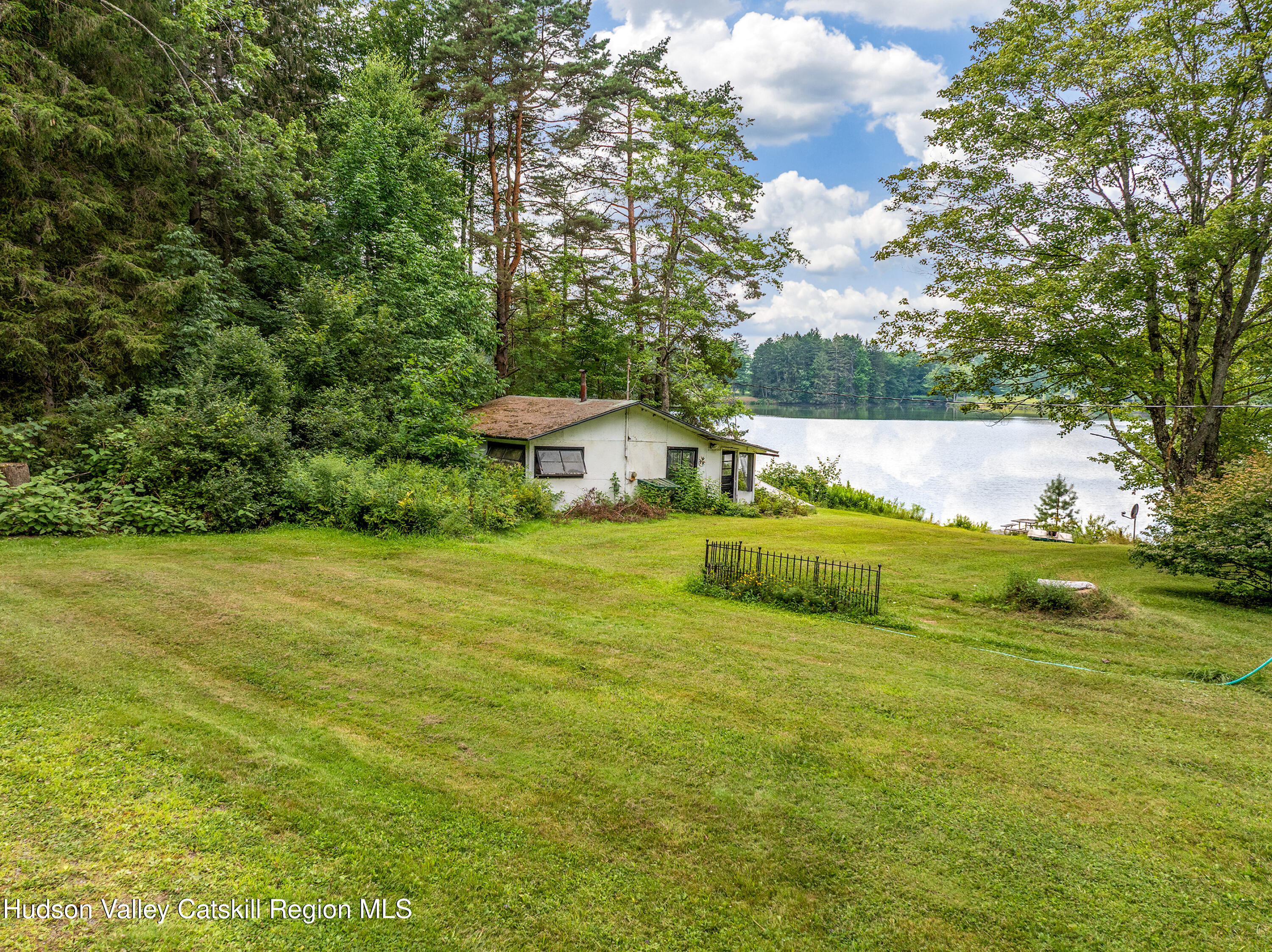 0 East Masonville Pond Road Sidney Center, NY 13839 - Photo 31 of 34 a view of a house with a garden and sitting area