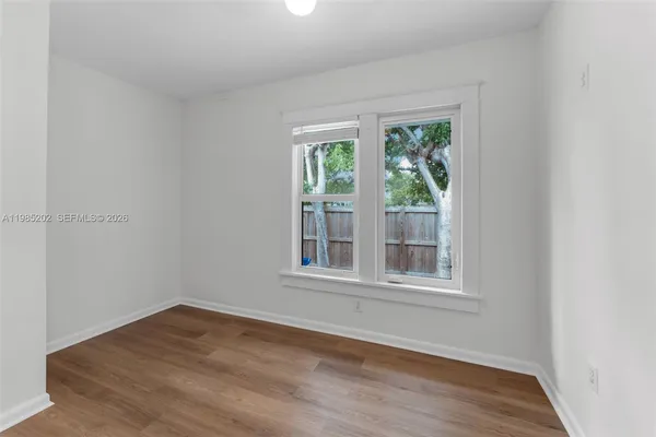 a bathroom with a toilet a sink and a window