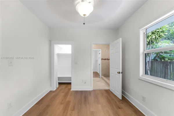 wooden floor in an empty room with a window