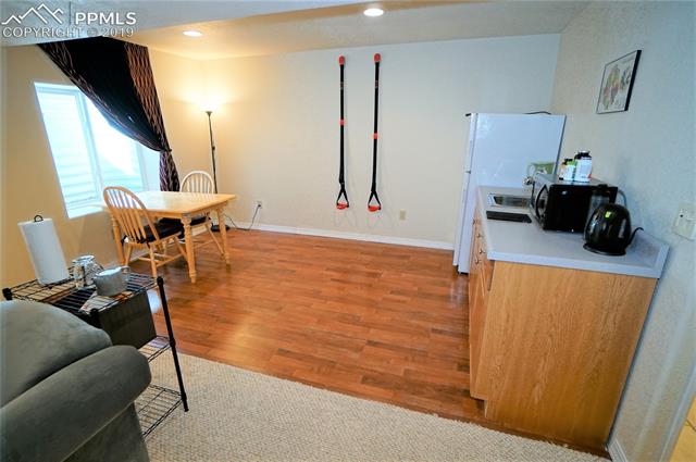 229 Avocet Loop Colorado Springs, CO 80921 - Photo 29 of 34 Wet bar with wood laminate flooring