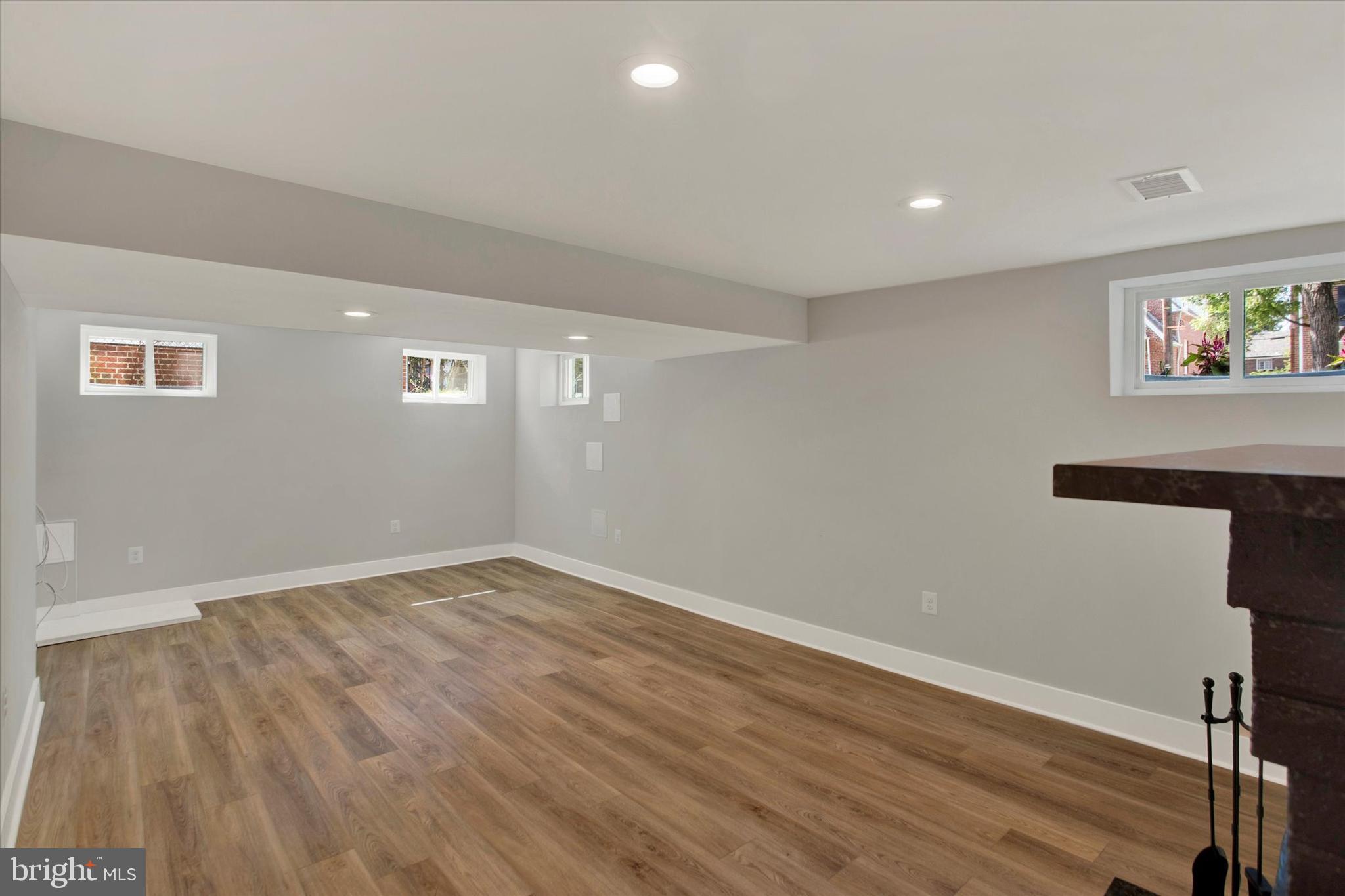 2054 34th Street Southeast Washington, DC 20020 - Photo 15 of 43 a view of an empty room with wooden floor and a window