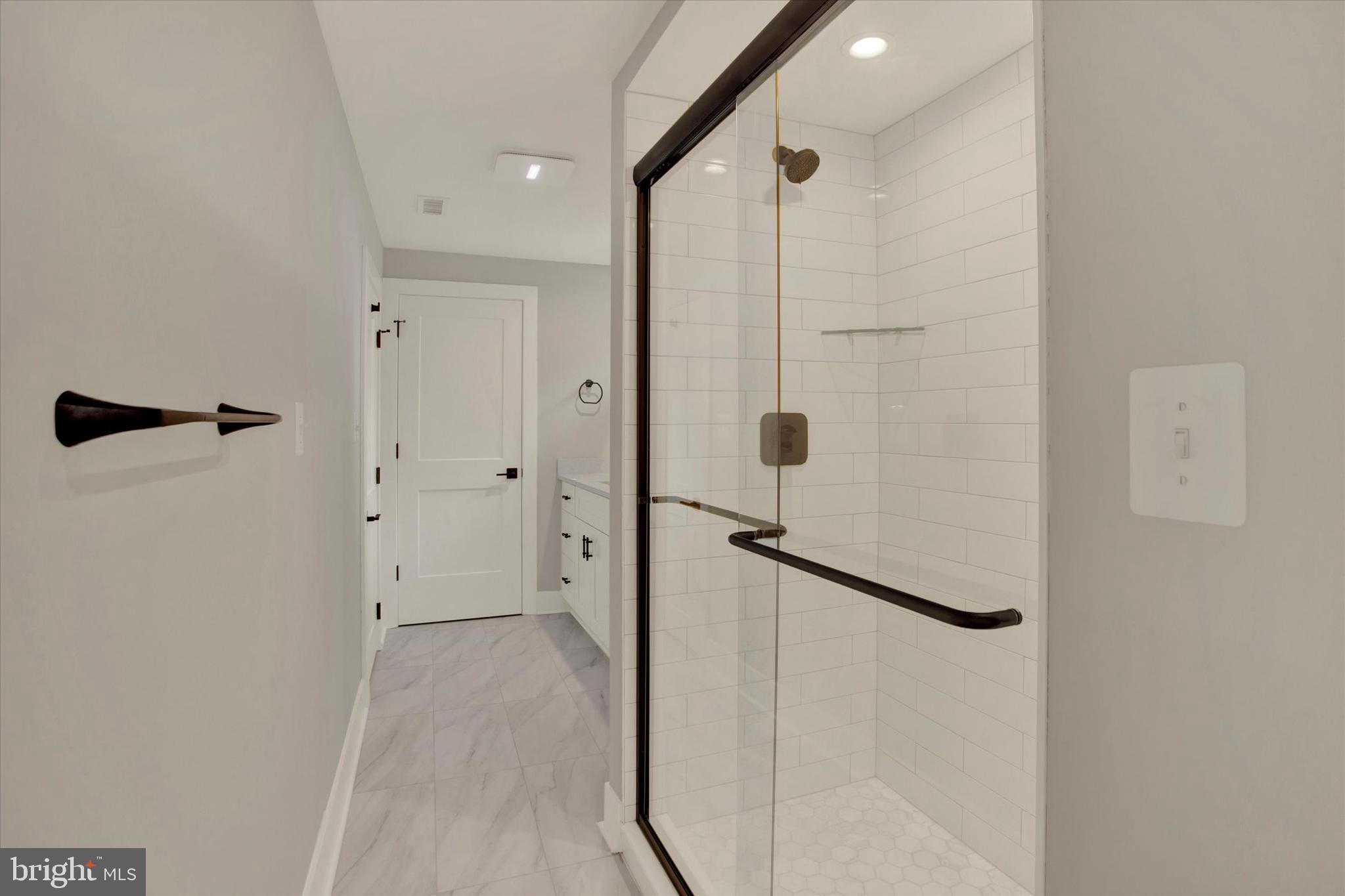 2054 34th Street Southeast Washington, DC 20020 - Photo 18 of 43 a bathroom with a shower and a glass door