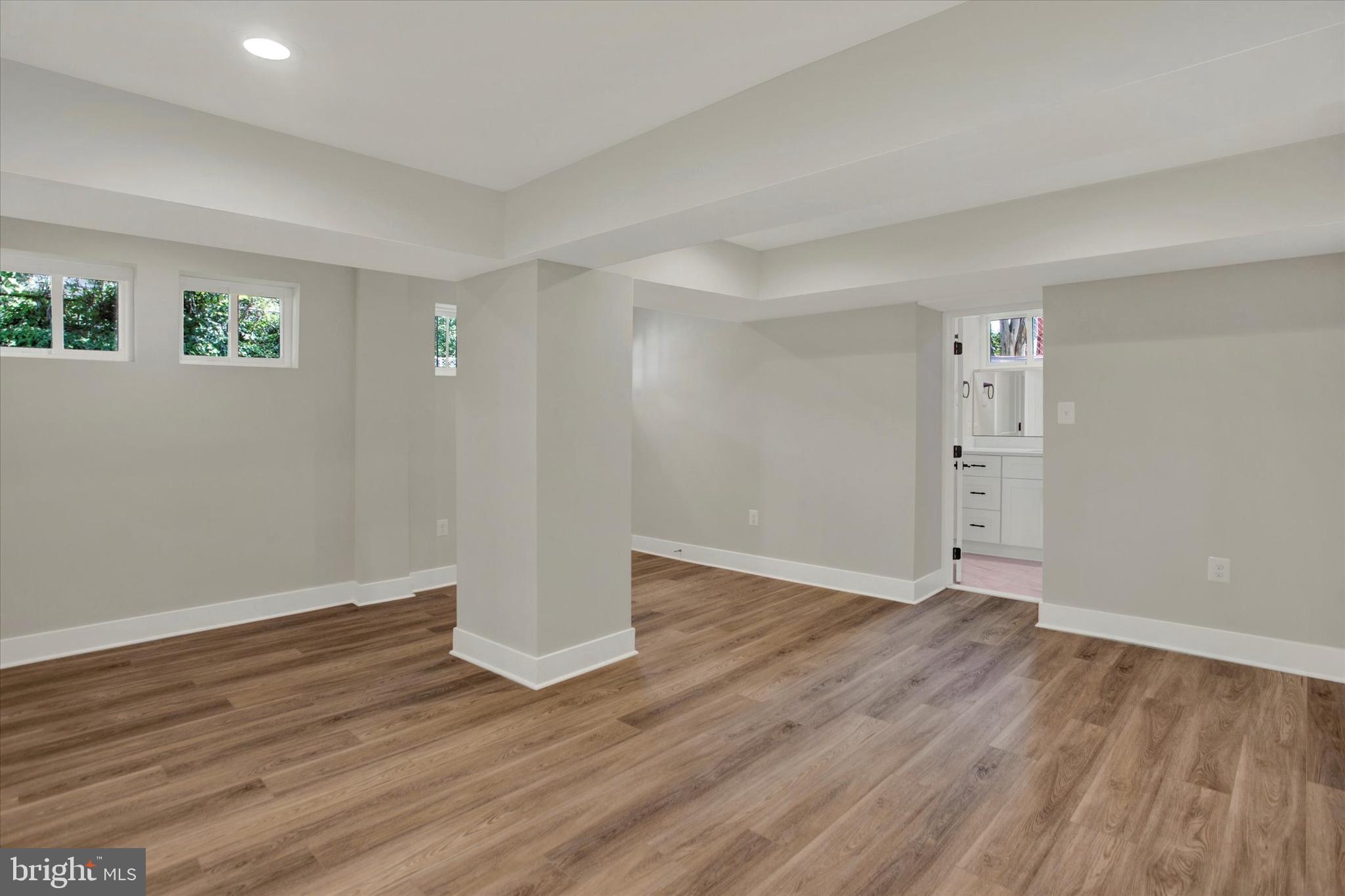 2054 34th Street Southeast Washington, DC 20020 - Photo 20 of 43 wooden floor in an empty room with a window