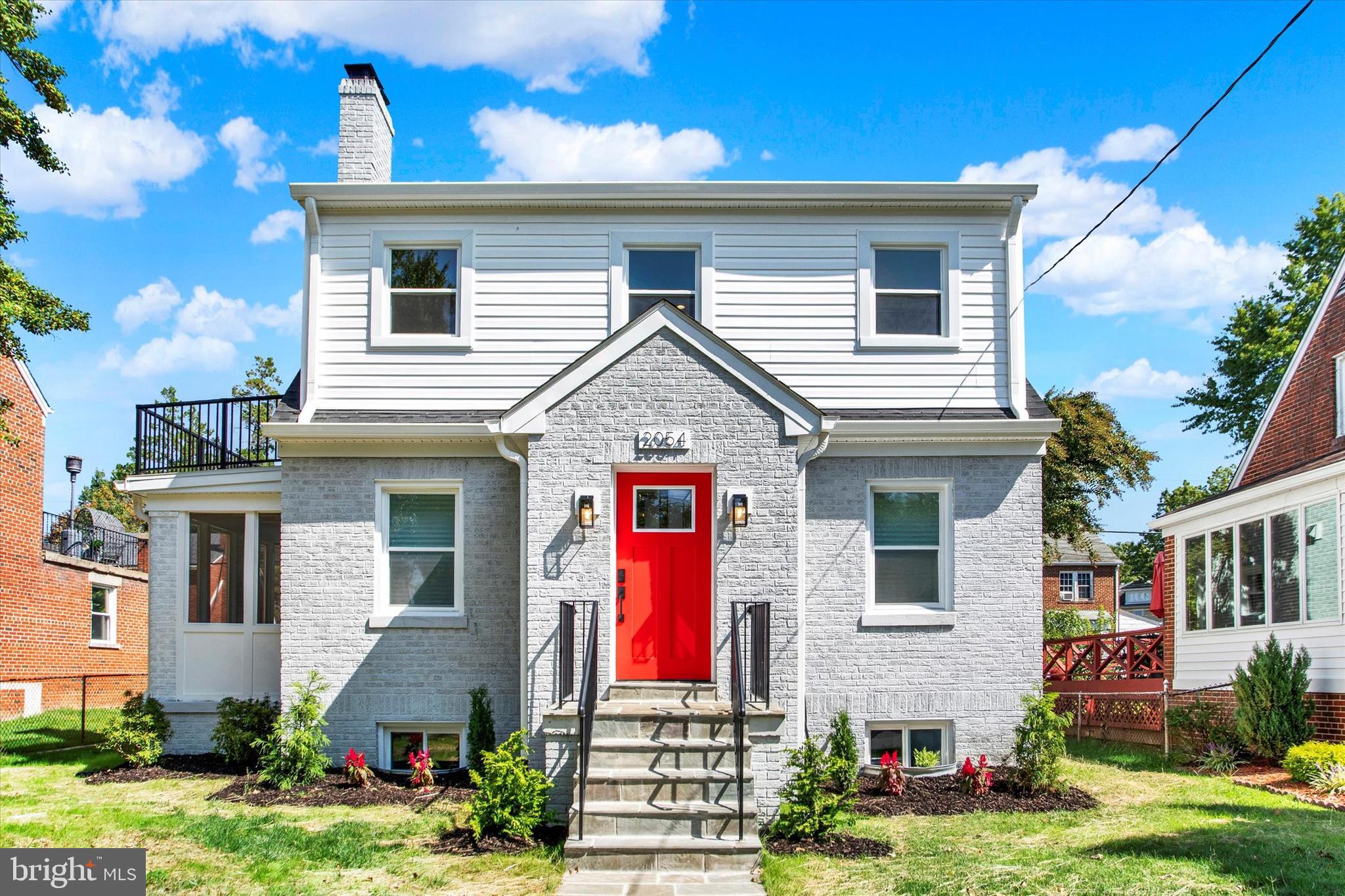 2054 34th Street Southeast Washington, DC 20020 - Photo 2 of 43 a front view of a house with a yard