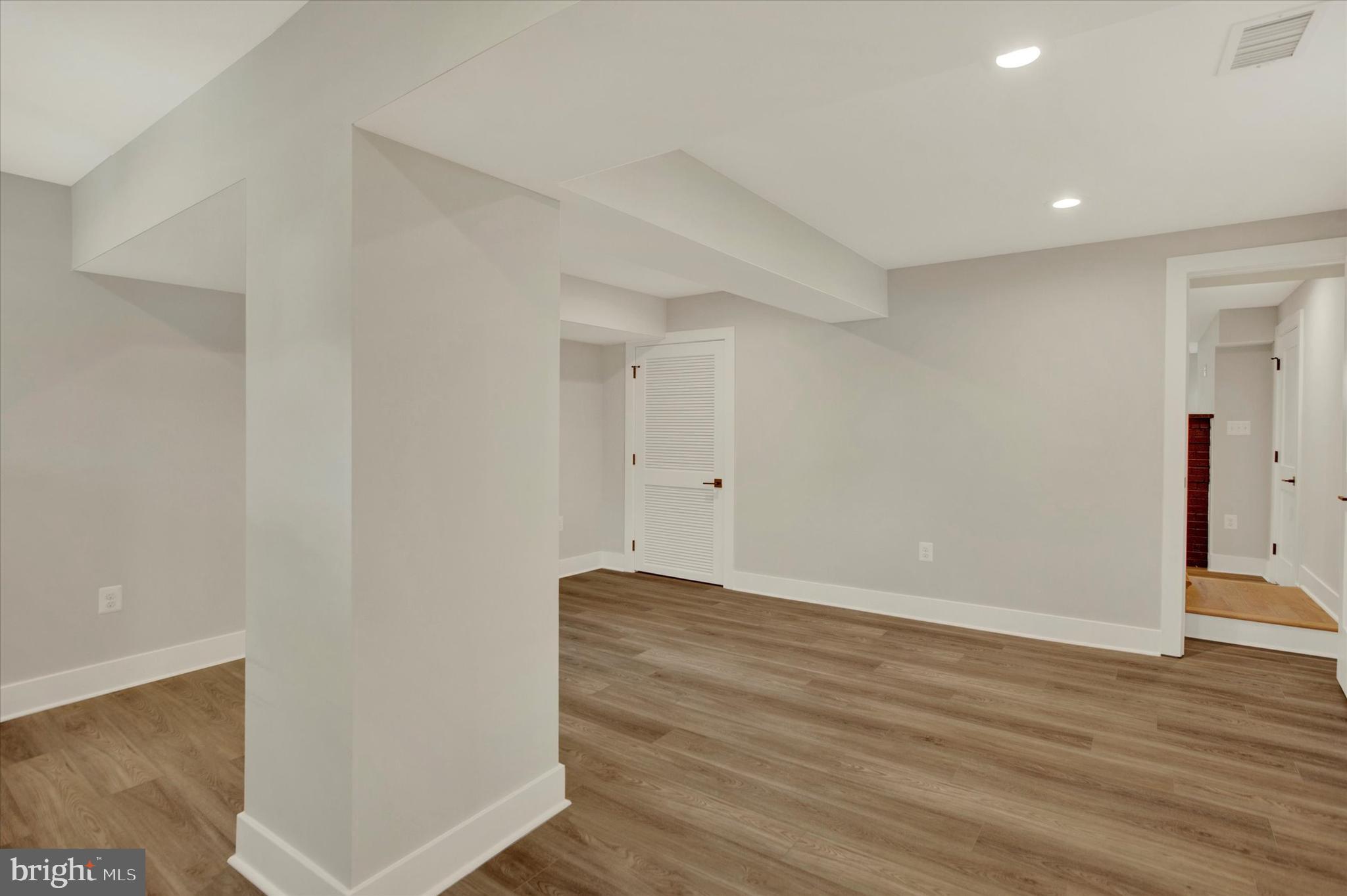 2054 34th Street Southeast Washington, DC 20020 - Photo 21 of 43 a view of room with wooden floor