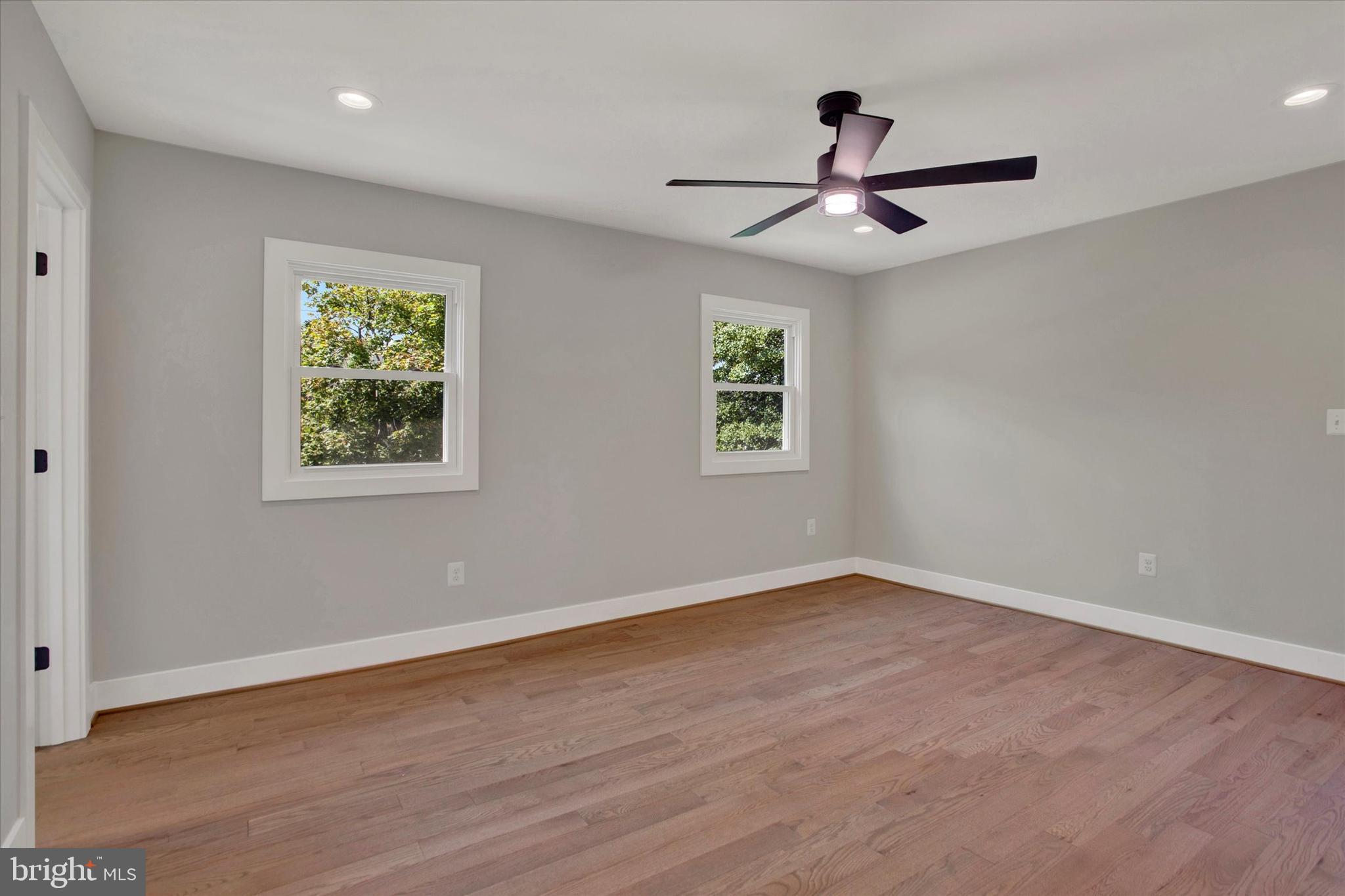 2054 34th Street Southeast Washington, DC 20020 - Photo 23 of 43 an empty room with wooden floor ceiling fan and window