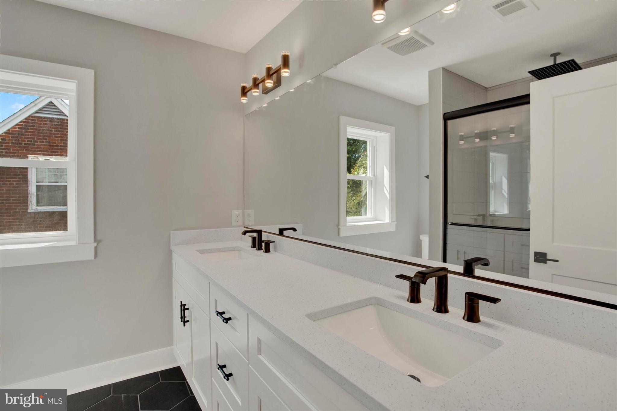 2054 34th Street Southeast Washington, DC 20020 - Photo 26 of 43 a bathroom with a sink and a mirror