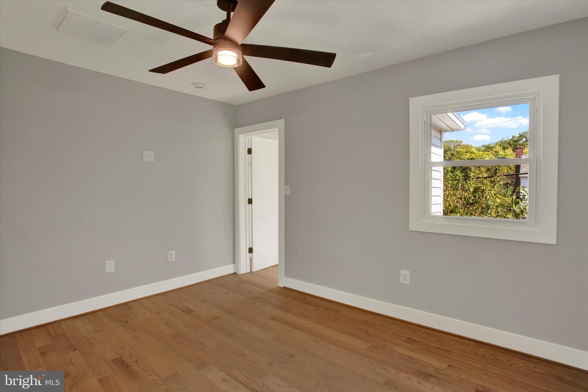 2054 34th Street Southeast Washington, DC 20020 - Photo 29 of 43 an empty room with a window and a ceiling fan