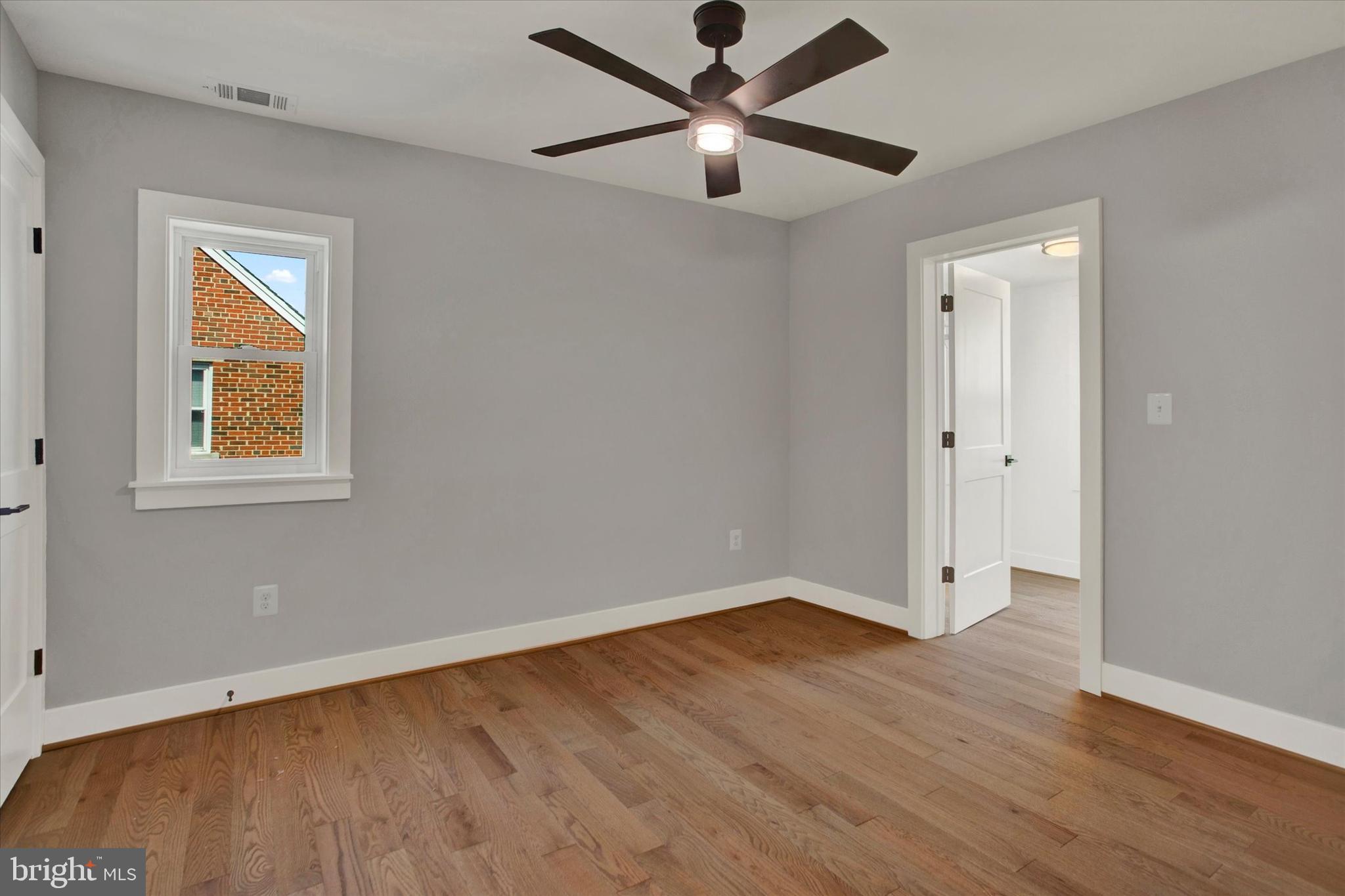 2054 34th Street Southeast Washington, DC 20020 - Photo 32 of 43 an empty room with a window and wooden floor