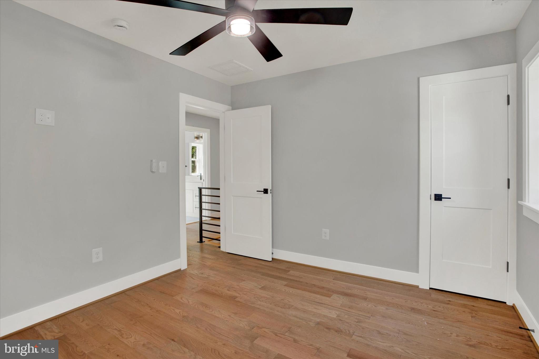 2054 34th Street Southeast Washington, DC 20020 - Photo 33 of 43 an empty room with wooden floor cabinet and windows