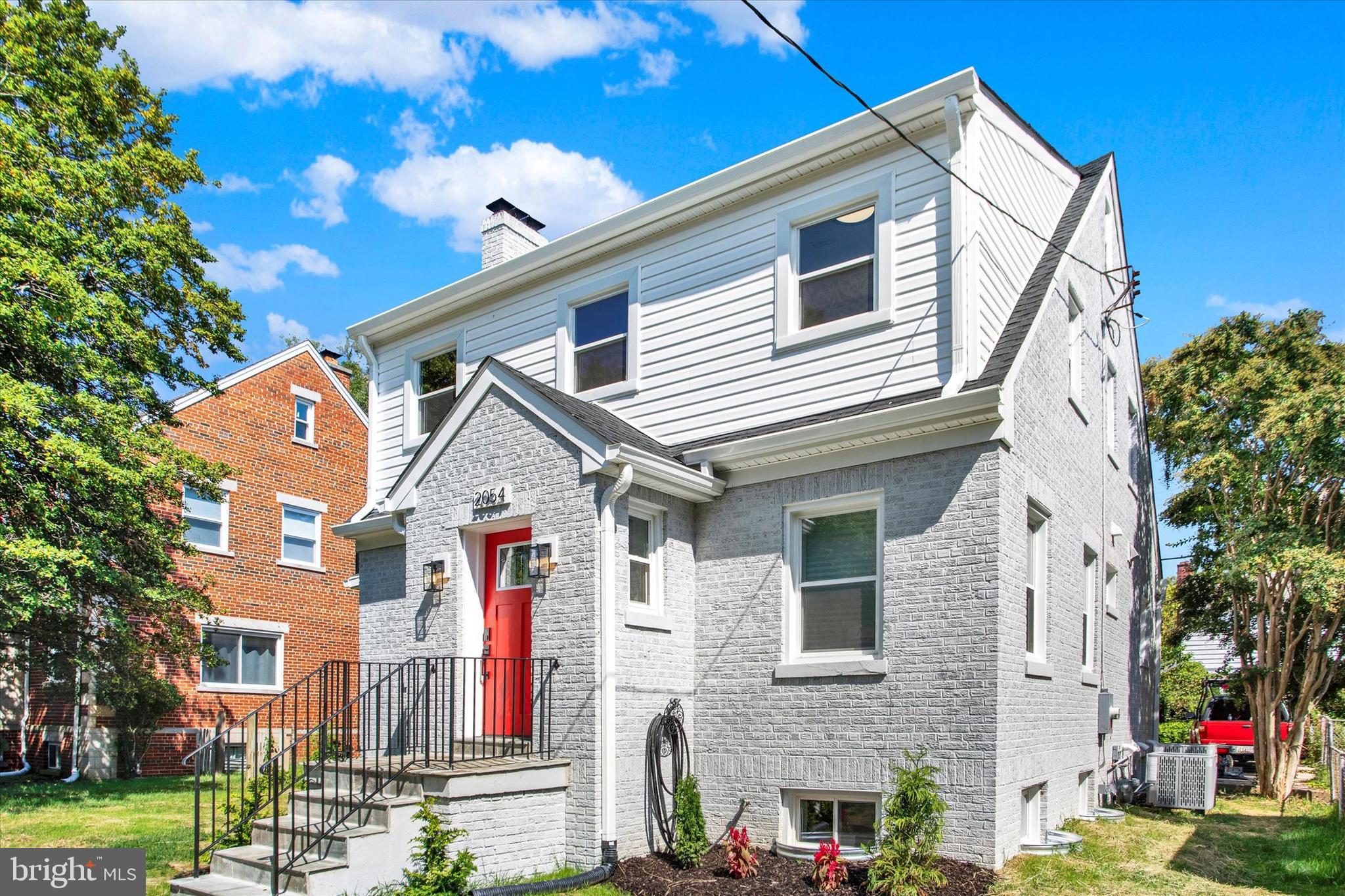 2054 34th Street Southeast Washington, DC 20020 - Photo 37 of 43 a front view of a house with a yard