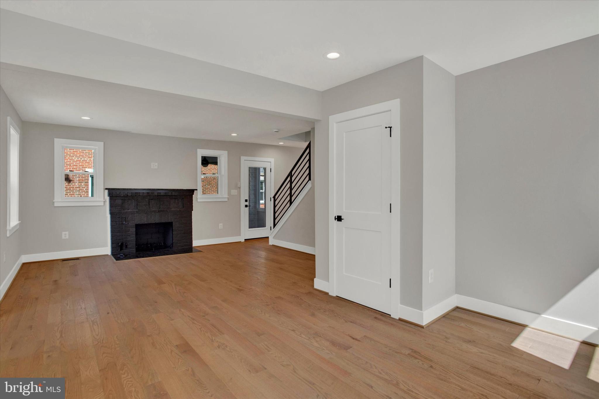 2054 34th Street Southeast Washington, DC 20020 - Photo 4 of 43 a view of a livingroom with wooden floor and a fireplace