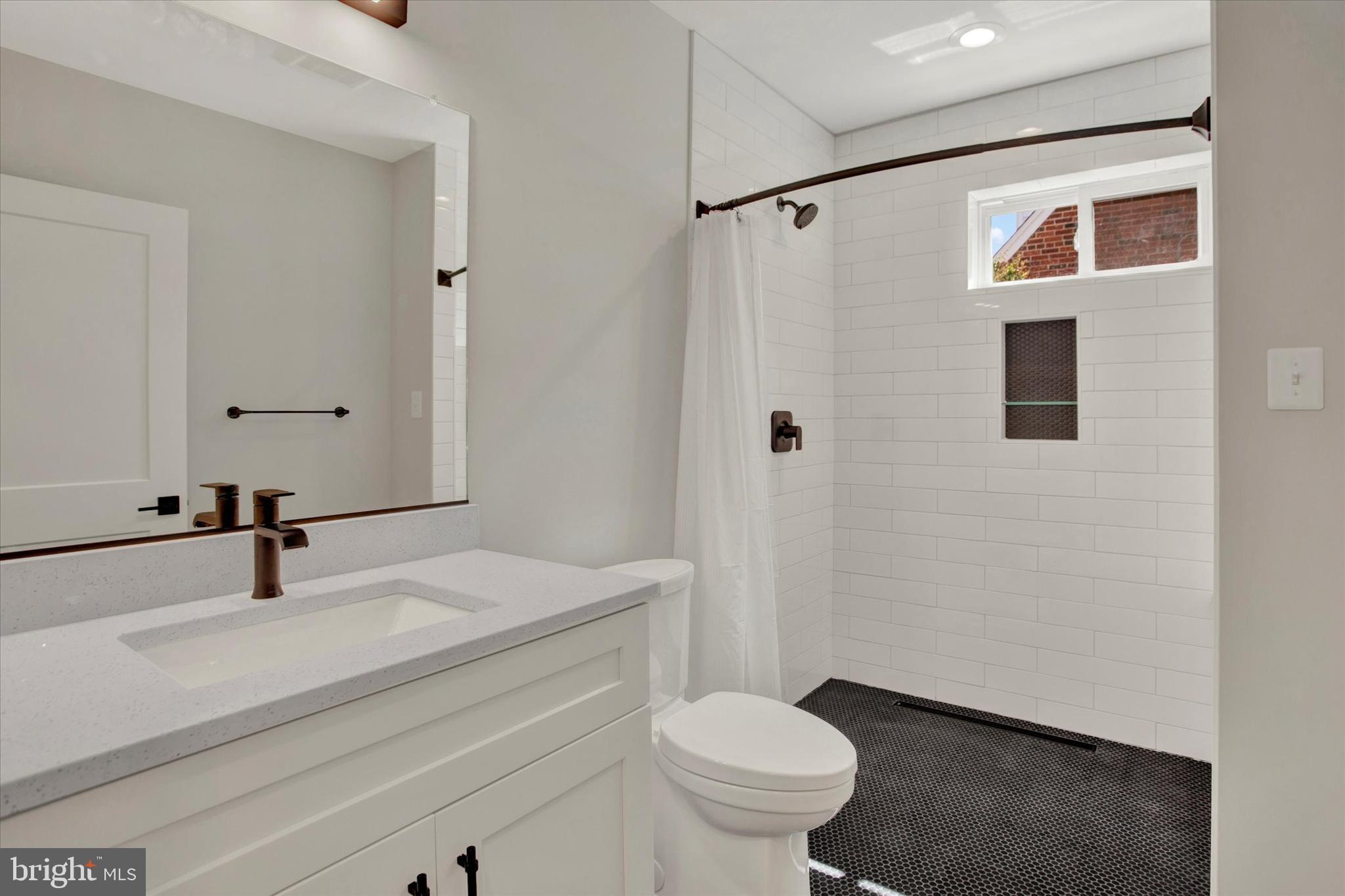 2054 34th Street Southeast Washington, DC 20020 - Photo 6 of 43 a bathroom with a sink and a toilet