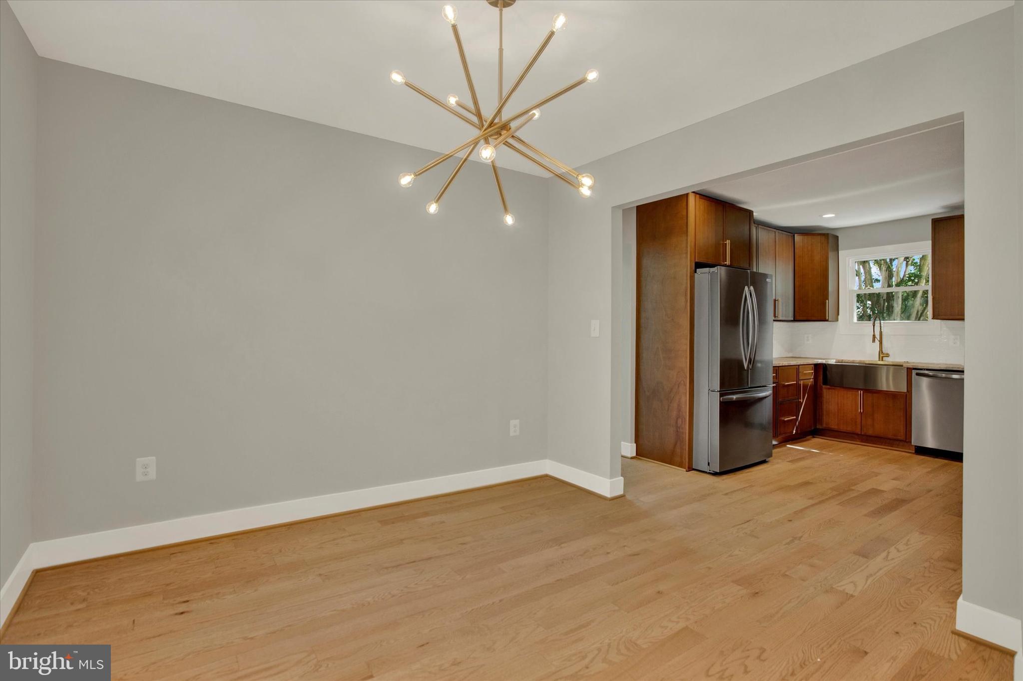 2054 34th Street Southeast Washington, DC 20020 - Photo 7 of 43 wooden floor in an empty room with a window