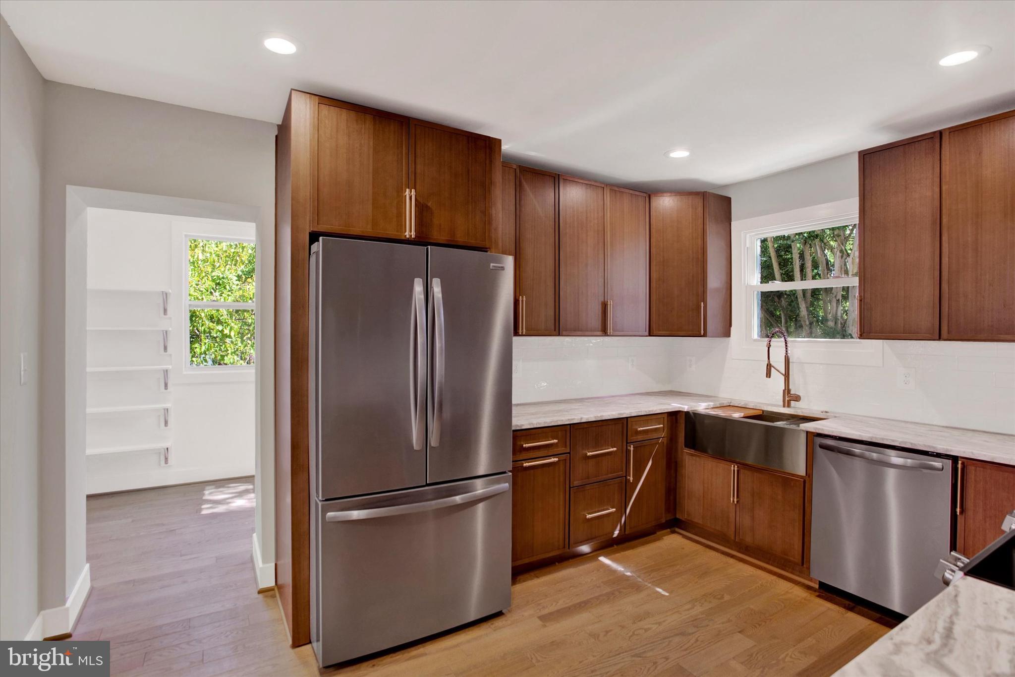 2054 34th Street Southeast Washington, DC 20020 - Photo 10 of 43 a kitchen with stainless steel appliances granite countertop a refrigerator a sink and a stove
