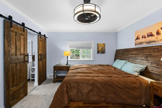 a bedroom with a bed and a chandelier