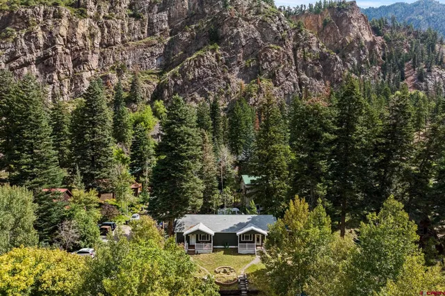 an aerial view of a house with yard and outdoor seating