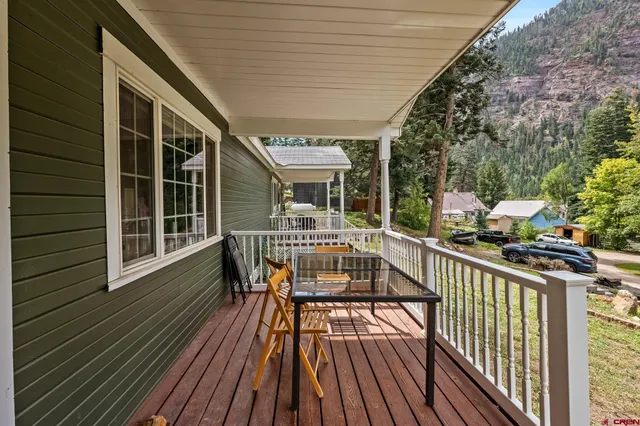 a living room with furniture ceiling fan and a window