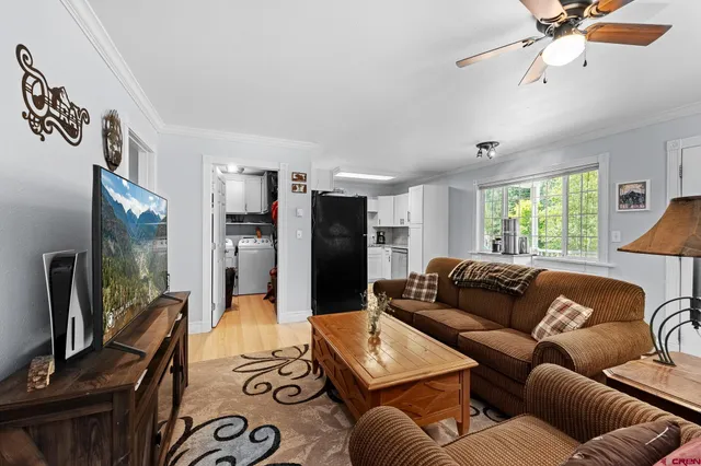 a living room with furniture and a flat screen tv