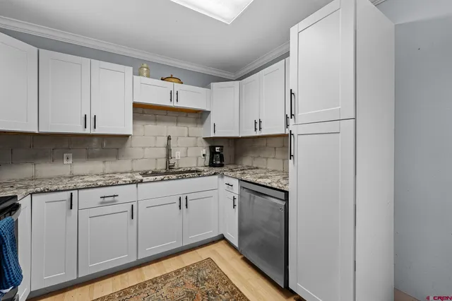 a kitchen with stainless steel appliances granite countertop a refrigerator and a stove top oven