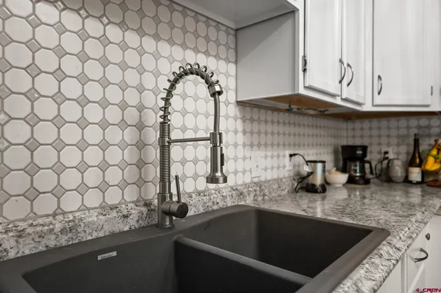 a kitchen with a sink and cabinets