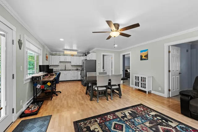 a living room with furniture a wooden floor and a window