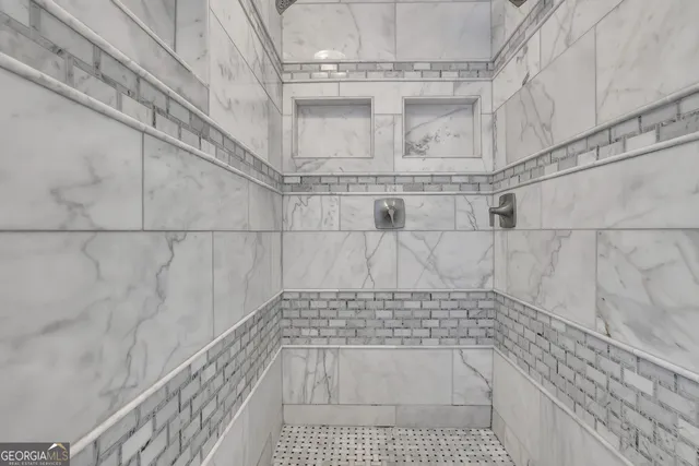 a bathroom with a granite countertop sink a toilet and shower