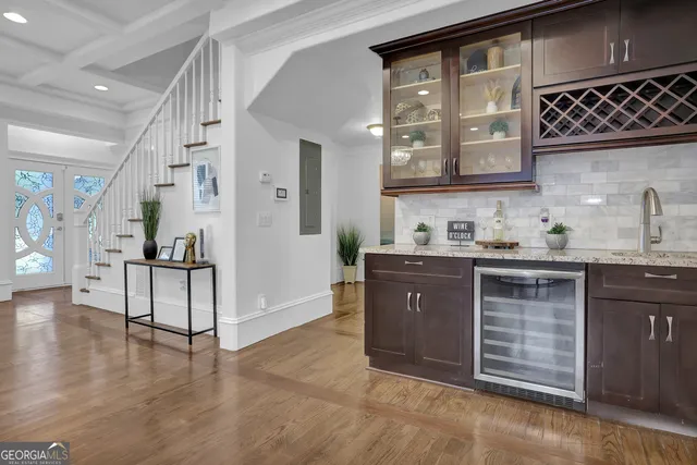 a kitchen with stainless steel appliances granite countertop a sink a stove a microwave a refrigerator and cabinets