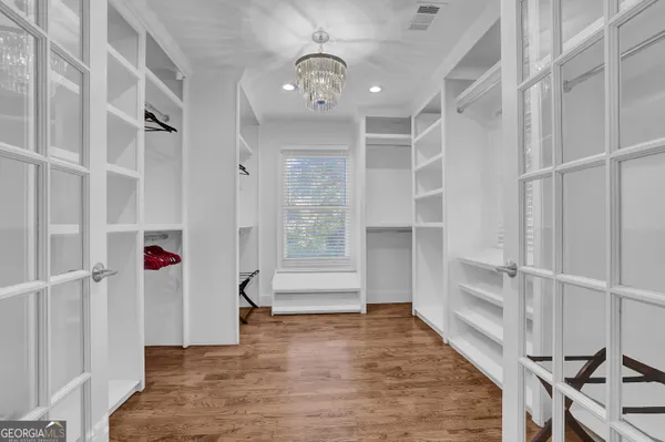 a bedroom with a large bed and a large window