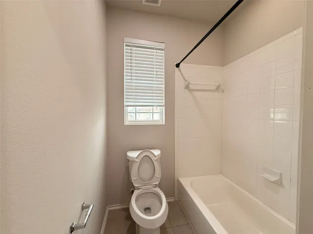 a bathroom with a toilet and a bathtub