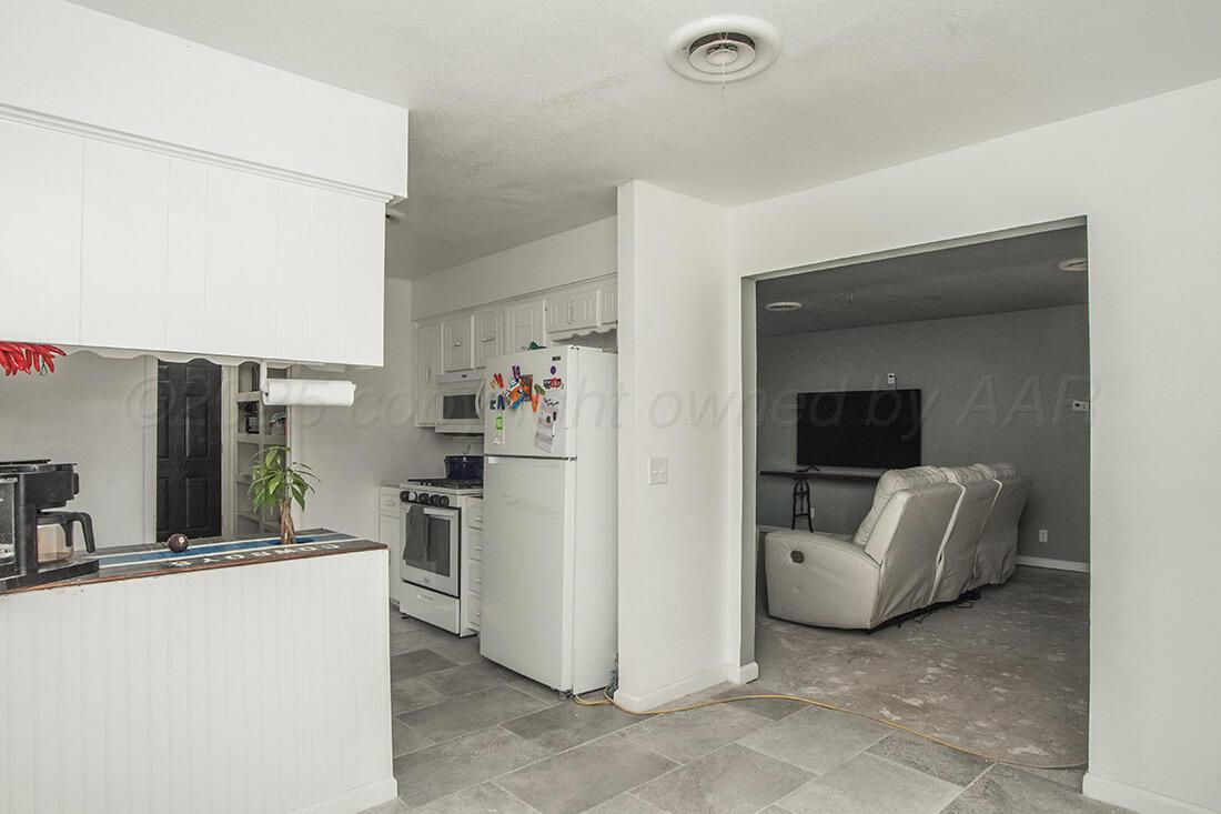 4206 Arden Road Amarillo, TX 79110 - Photo 5 of 24 a view of kitchen with furniture and a refrigerator