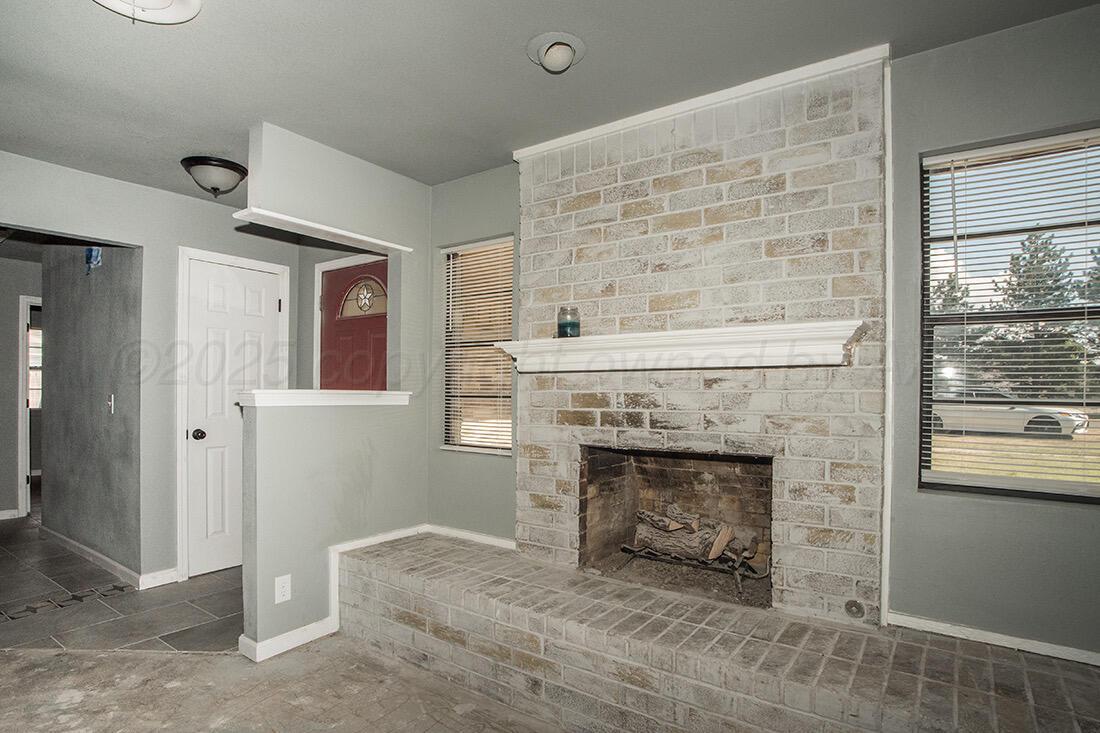 4206 Arden Road Amarillo, TX 79110 - Photo 8 of 24 an empty room with windows and fireplace