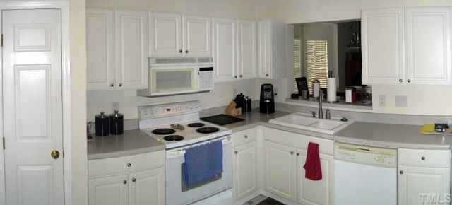 4452 Still Pines Drive Raleigh, NC 27613 - Photo 6 of 10 Loads of cabinets and counter space, new dual-basin sink with detachable faucet spray wand, pass-thru to the dining area, pantry and much more! Other