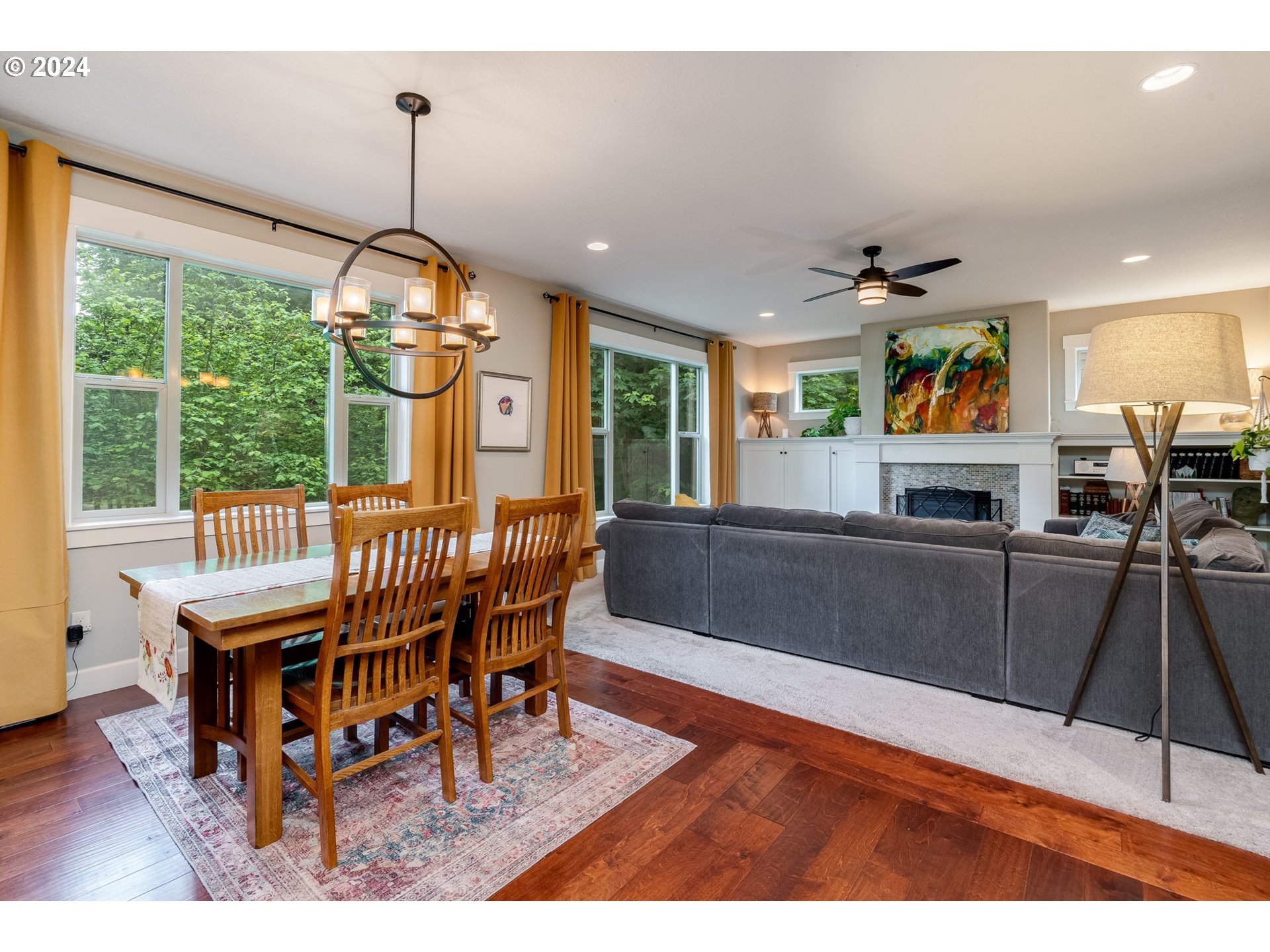 15057 Southeast Glenbrook Road Happy Valley, OR 97015 - Photo 12 of 43 a dining room with furniture a chandelier and wooden floor