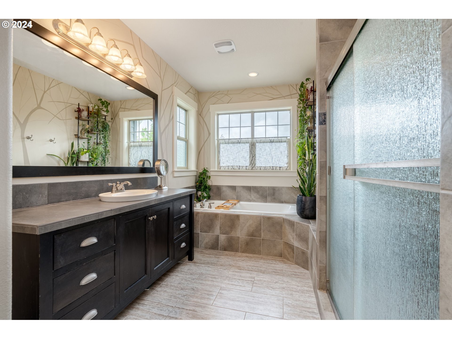 15057 Southeast Glenbrook Road Happy Valley, OR 97015 - Photo 19 of 43 a bathroom with a tub sink and mirror