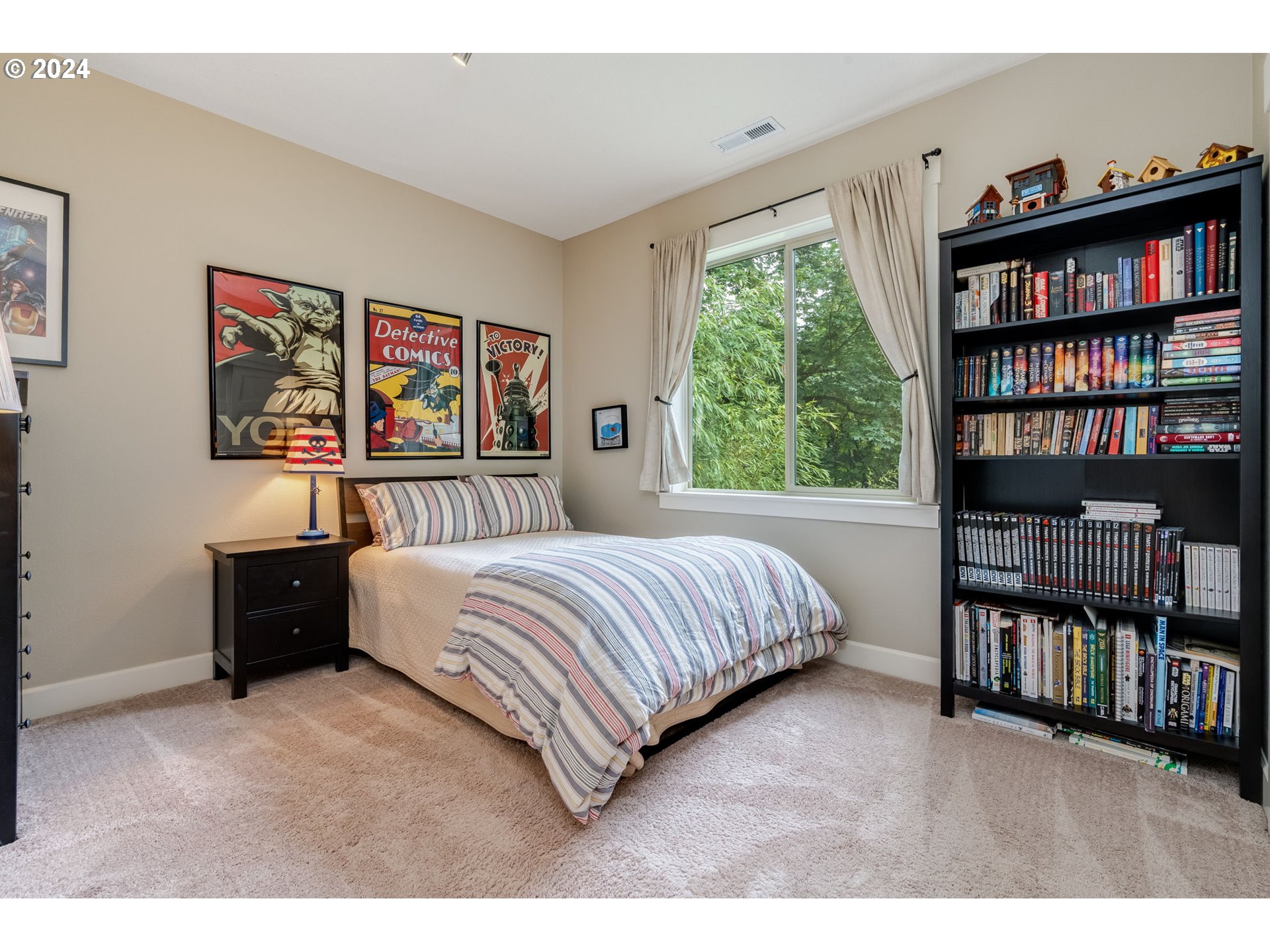 15057 Southeast Glenbrook Road Happy Valley, OR 97015 - Photo 22 of 43 a bedroom with a large bed and a book shelf