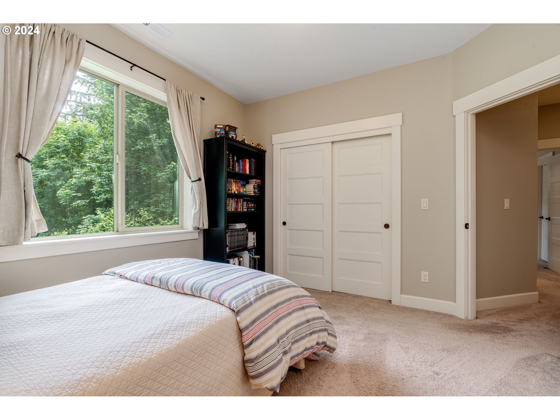 15057 Southeast Glenbrook Road Happy Valley, OR 97015 - Photo 23 of 43 a bedroom with a bed and a large window