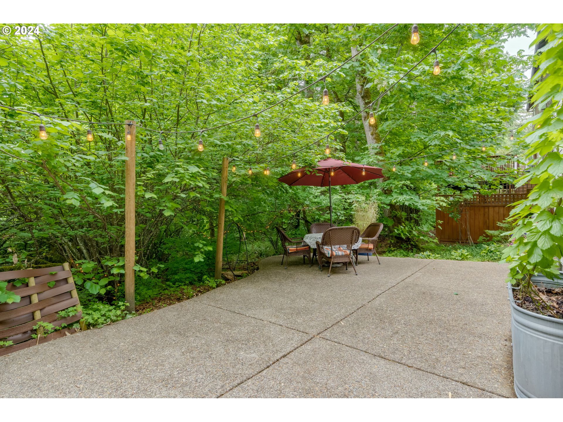 15057 Southeast Glenbrook Road Happy Valley, OR 97015 - Photo 35 of 43 a view of backyard with a table and chairs